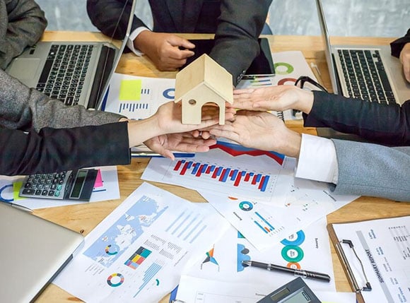 Financial Consultants Holding a wooden house | Bighorn Capital Fund in Laramie, WY